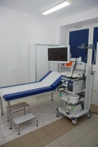 łóżko medyczne koloru biało niebieskiego wraz z aparatem do endoskopii koloru białego w dziale Endospkopii